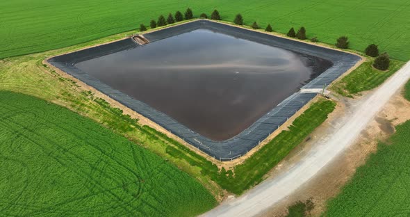 Water in retention basin at farm. Agriculture protect runoff and stormwater. Aerial in rural America alt
