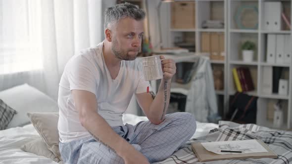 Man Drinking Tea and Watching Movie alt
