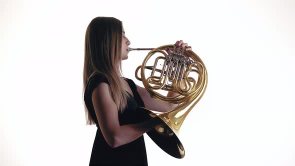 Young Beautiful Plays the French Horn