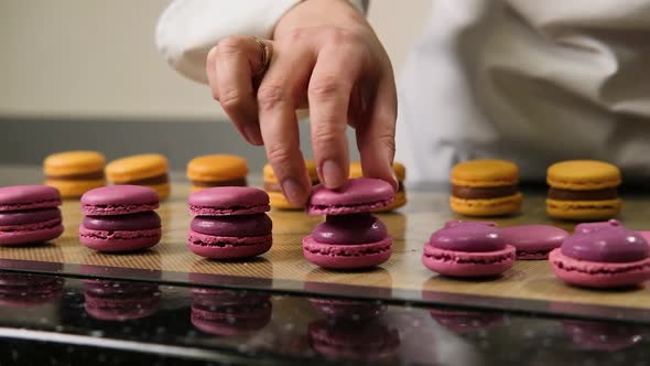 The Pastry Chef Assembles Macarons with Strawberry Cream alt