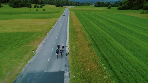 Team of Cyclists Ride in Beautiful Scenery alt