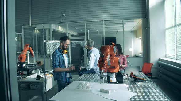 Young Engineers are Supervising an Experiment with Lab Robots alt