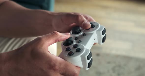 Close Up of Playing Video Games While Holding a Game Controller alt
