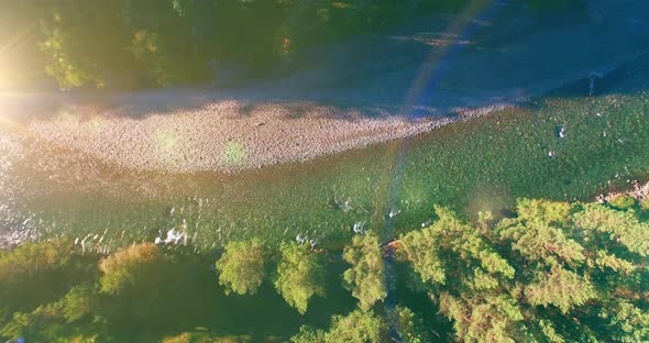 Low Altitude Flight Over Fresh Fast Mountain River with Rocks at Sunny Summer Morning. alt
