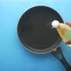 Pouring Sunflower Oil on Cooking Pan on Blue Background - VideoHive Item for Sale