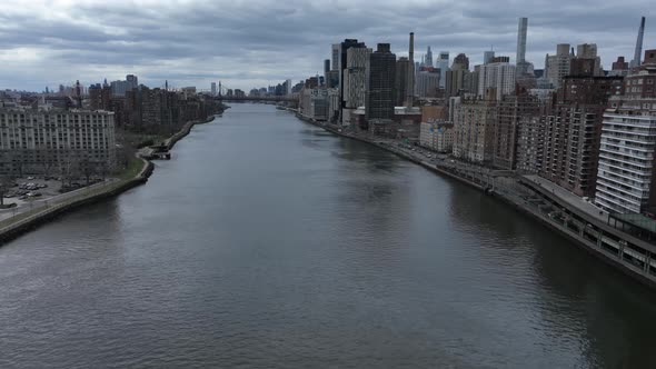 An aerial time-lapse over the east river with Roosevelt Island and Manhattan's Eastside in view on a alt