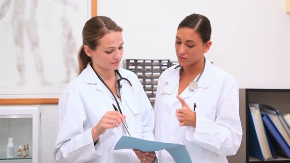 Doctors looking at a folder alt