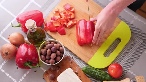 Greek Salad Preparation Series Concept  Woman Cutting Red Pepper alt