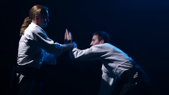 Fight Between Two Aikido Fighters in Dark Studio. Slow Motion. Close Up. alt