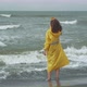 Woman In Raincoat Standing In Waving Sea - VideoHive Item for Sale