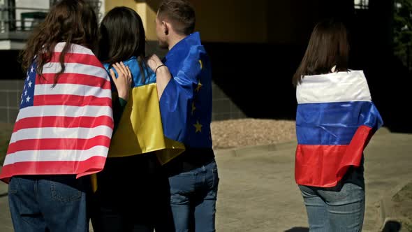 Group of Hugging People with the Flags of Ukraine the USA and the EU alt
