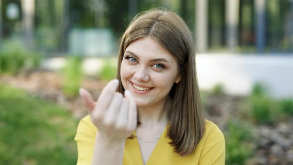 European Ukraininan Girl Pointing Index Finger at Camera Inviting With Hand Gesture