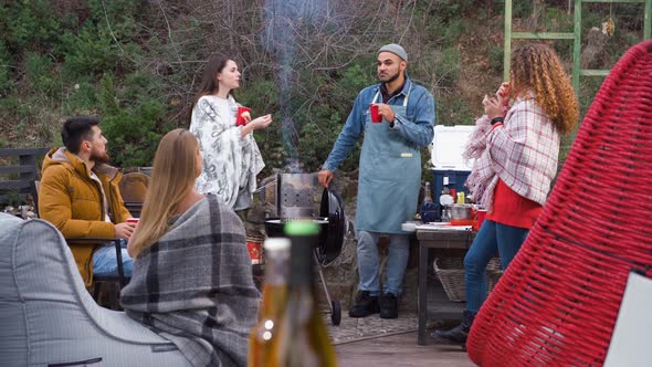 Friends Having a Barbecue Party in Backyard at Autumn