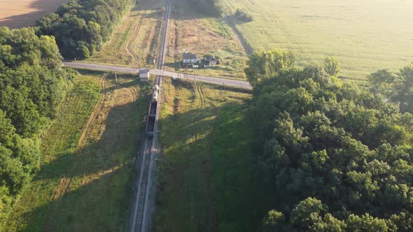 A Freight Train Crosses the Highway at the Crossing alt