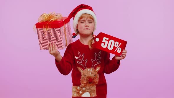 Child Girl in Christmas Hat Showing Gift Box and 50 Percent Discount Inscriptions Banner Text Note alt