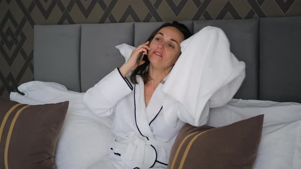 Woman in Bathrobe Drying Hair After Shower in Bed alt