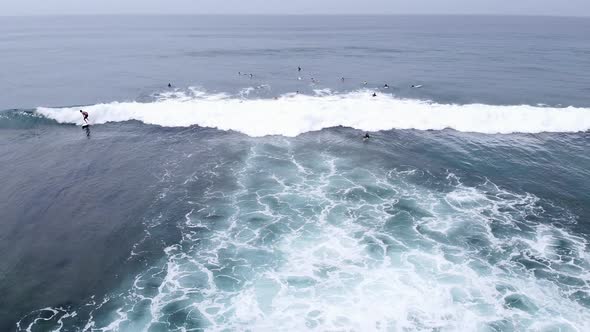 Aerial Drone Footage of Surfers Waiting for the Next Ride on the Big Ocean Wave on Beautiful Aerial