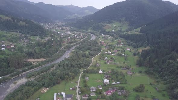 Aerial summer view to Carpathian village Kryvorivnia amidst mountains alt