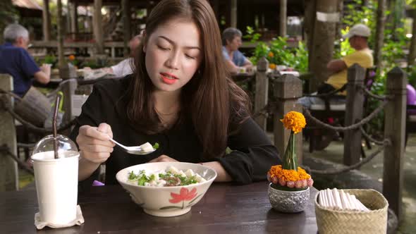 Asian Girl Eating Laos Food alt