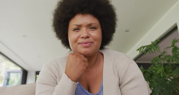 Video of happy plus size african american woman having video call alt