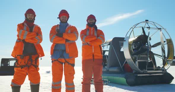 Coast Guard Team with Arms Crossed Posing at Camera Over Frozen Lake alt