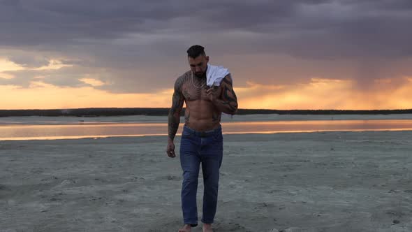 Masculine Man on Shore at Sunset