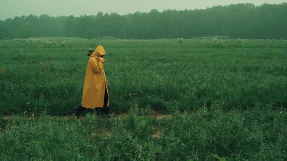 Maniac in a Yellow Raincoat Throws an Axe at a Fleeing Woman in a Blue Raincoat alt