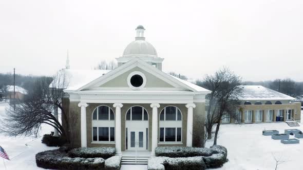 Winter time church as snow falls. alt