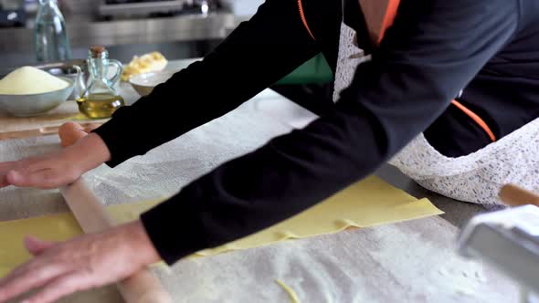 Mature woman working inside pasta factory
