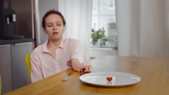 Anorexic Woman Feels Dizzy Depleted By Severe Diet Trying To Eat Tomato alt