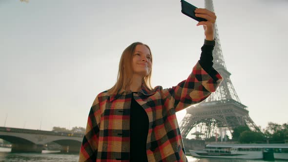 Young Woman Takes Selfie Photo By Smartphone with Eiffel Tower in Paris France