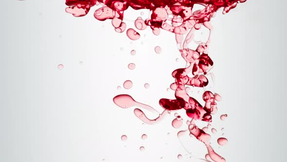 Transparent Cosmetic Red Oil Bubbles and Shapes on White Background