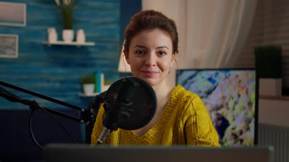 Woman Blogger Sitting in Home Studio Looking at Camera alt