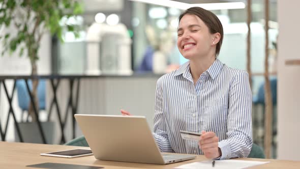 Successful Online Payment on Laptop By Young Woman in Office  alt