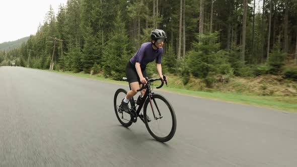 Cyclist hard training on bicycle, doing cardio workout exercises, preparing for cycling competition alt
