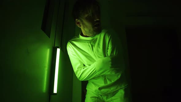A Mad Male Patient is Trying to Get Out of Straitjacket in Mental Hospital alt
