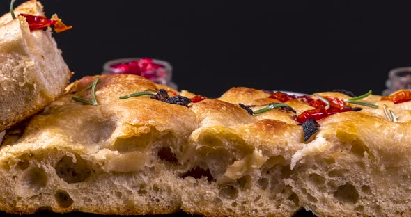 Homemade italian flat bread - Focaccia contorta. With olives, olive oil, rosemary, tomatoes. Traditi alt