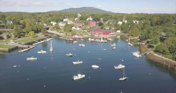 Rockport Harbor, Maine on a beautiful sunny day with ships heading out to sea. alt