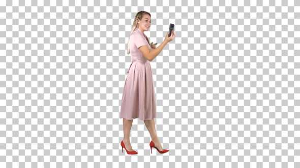 Young woman in pink holding using smart phone recording video alt