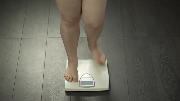 Healthy Diet, Chubby Female Stepping on Scales to Check Weight, Body Control alt