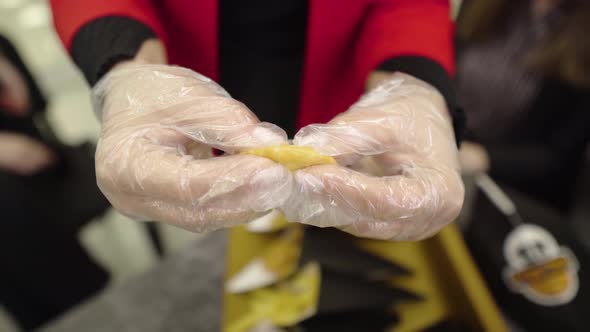 Closeup Hands Breaking Apart a Snack with Stuffing