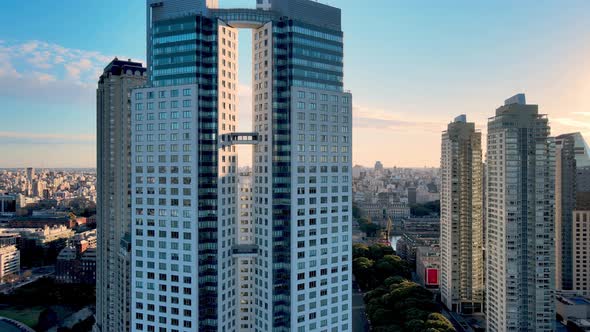 4K Aerial Drone Footage Orbiting Around Modern Apartment Buildings with Beautiful Sunset and City vi alt