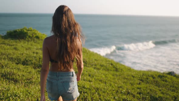 Slim Woman Walking to Banawa Beach Cliff Edge