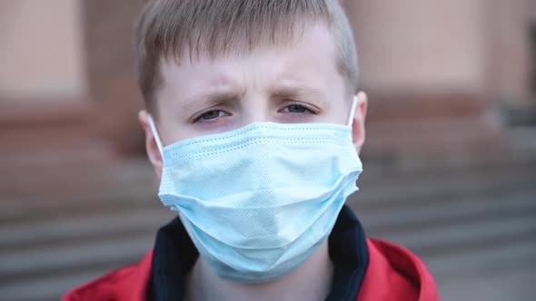 Portrait of Little Boy Wearing Medical Mask on Street in City