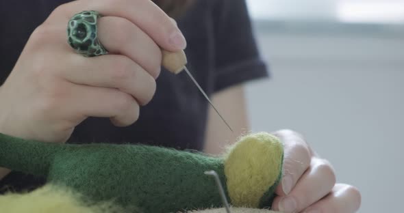 Woman Making Wool Art Doll Toy at Table Close Up. Female Sitting and Creating Ooak Doll at Home alt