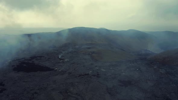 Volcano Smoke Rising From The Ground. Lava Field After Volcanic Eruption. drone forward alt