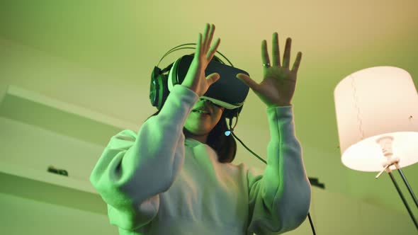 Young Woman with VR Headset Experiencing Virtual World for First Time alt