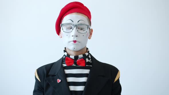 Slow Motion of Funny Mime Artist Rolling Eyes with Serious Face Standing on White Background alt