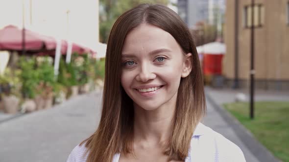 Close-up portrait of cheerful young woman.