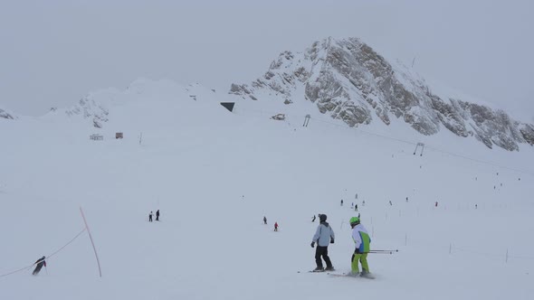 People skiing on a ski slope alt